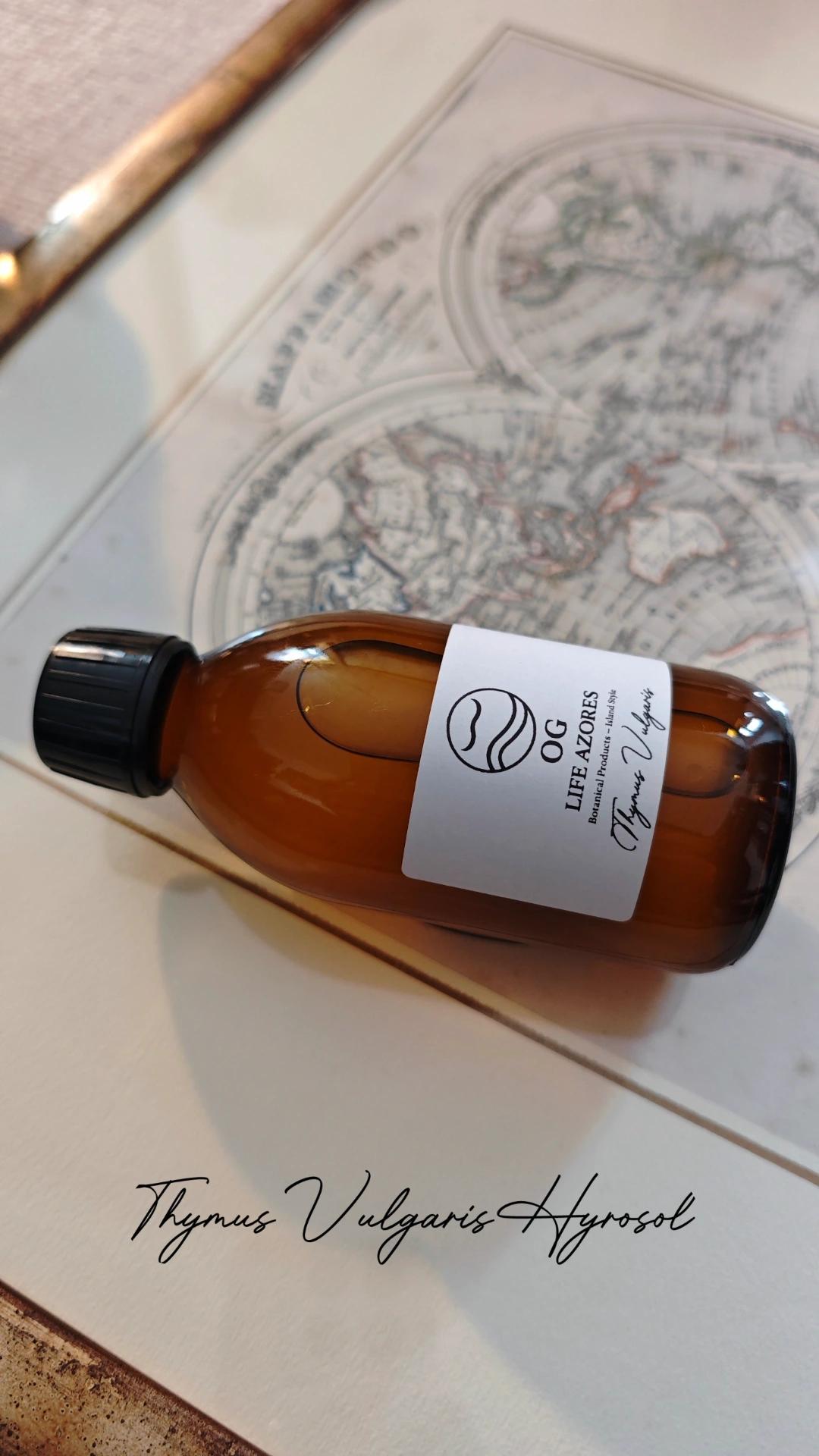 Thymus Vulgaris hydrosol bottle with label on an antique map